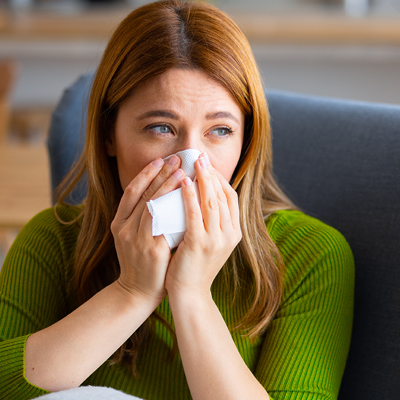 Woman blowing her nose
